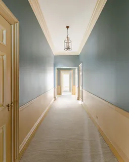 a view of a hallway with a chandelier