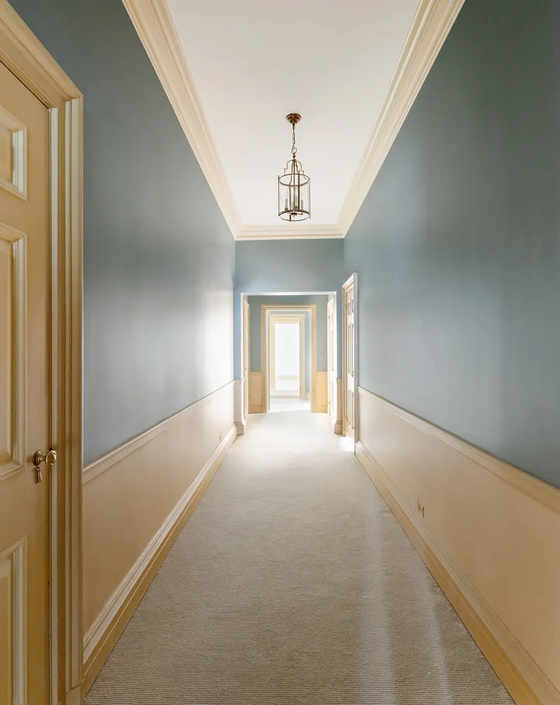 a view of a hallway with a chandelier
