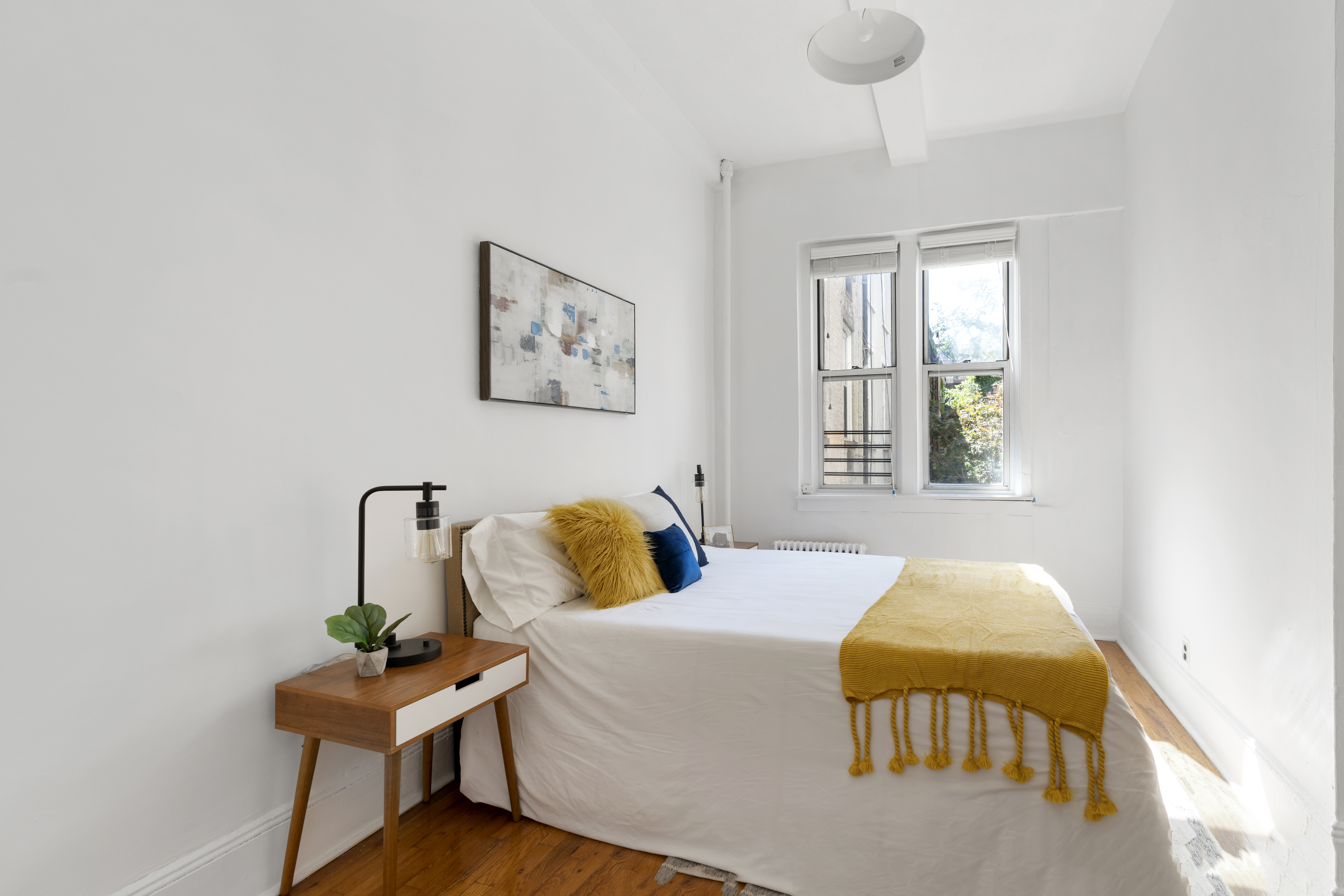 458 West 20th Street, Unit 3D Manhattan, NY 10011 - Photo 5 of 9 a bedroom with a bed and a window