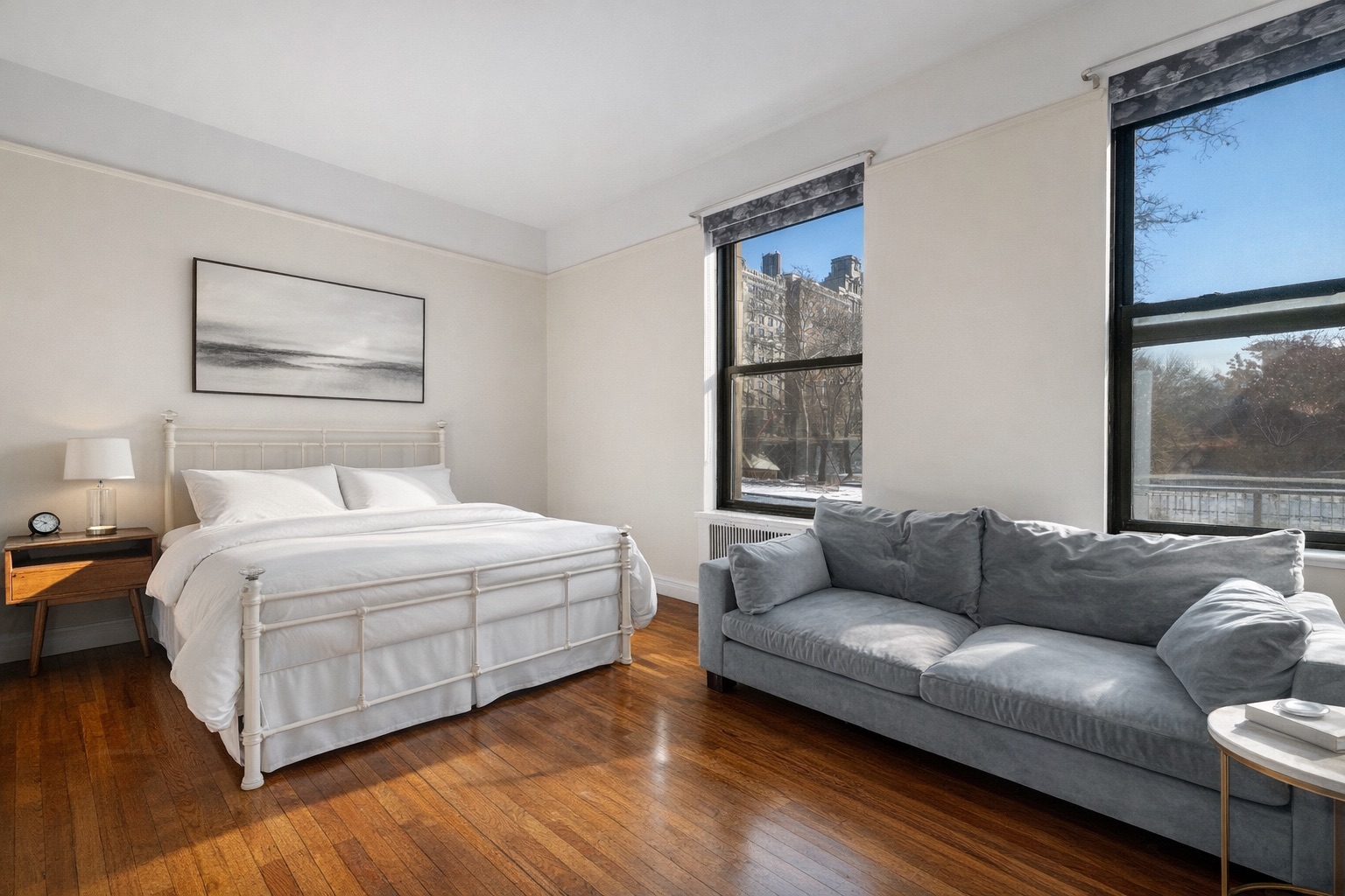 a bedroom with a bed couch and window