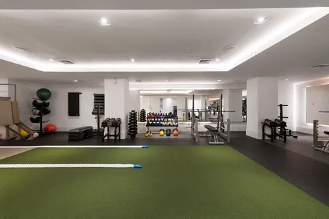 a view of a room with gym equipment and a large window
