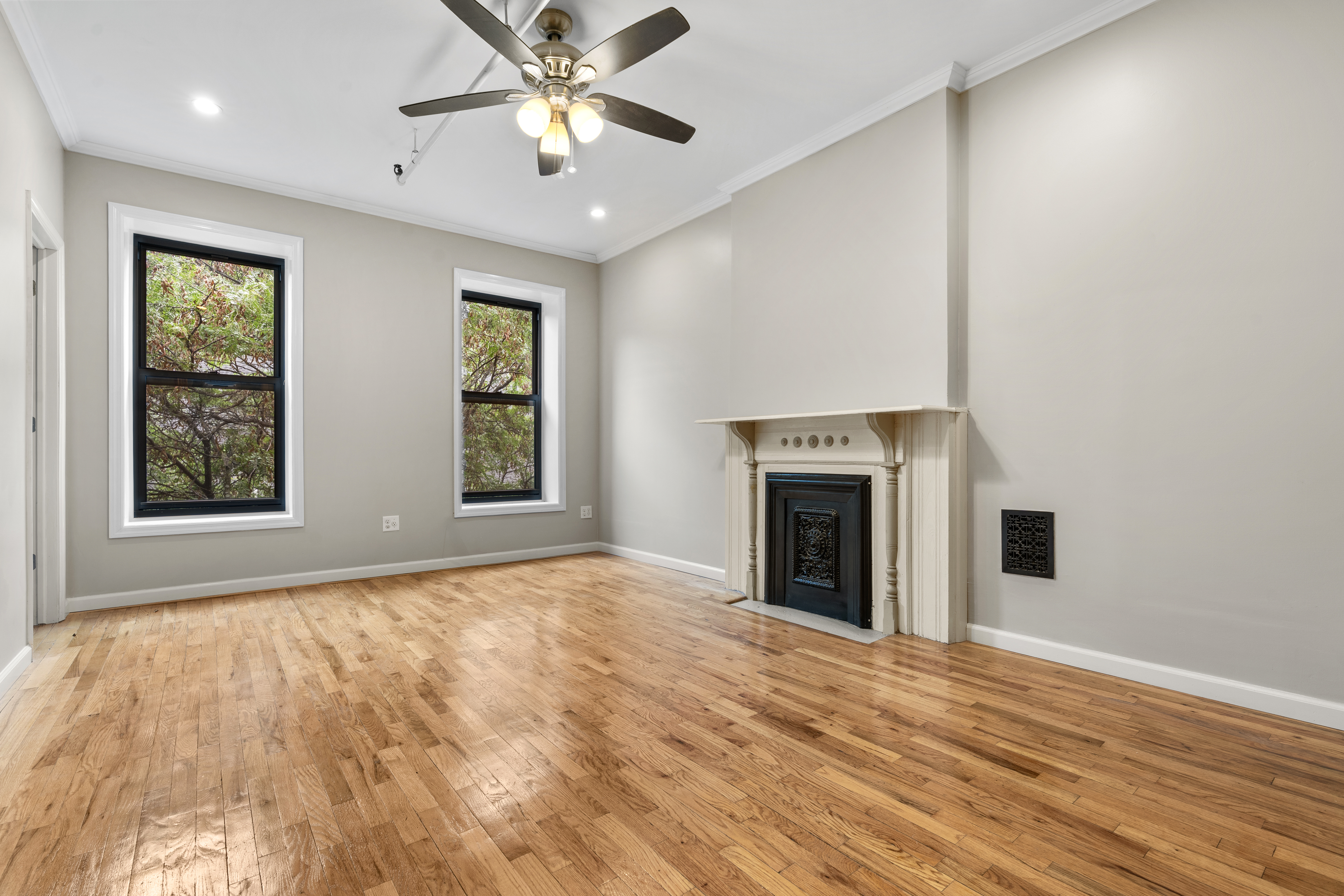 615 Putnam Avenue, Unit 4 Brooklyn, NY 11221 - Photo 8 of 10 a view of an empty room with window and fireplace