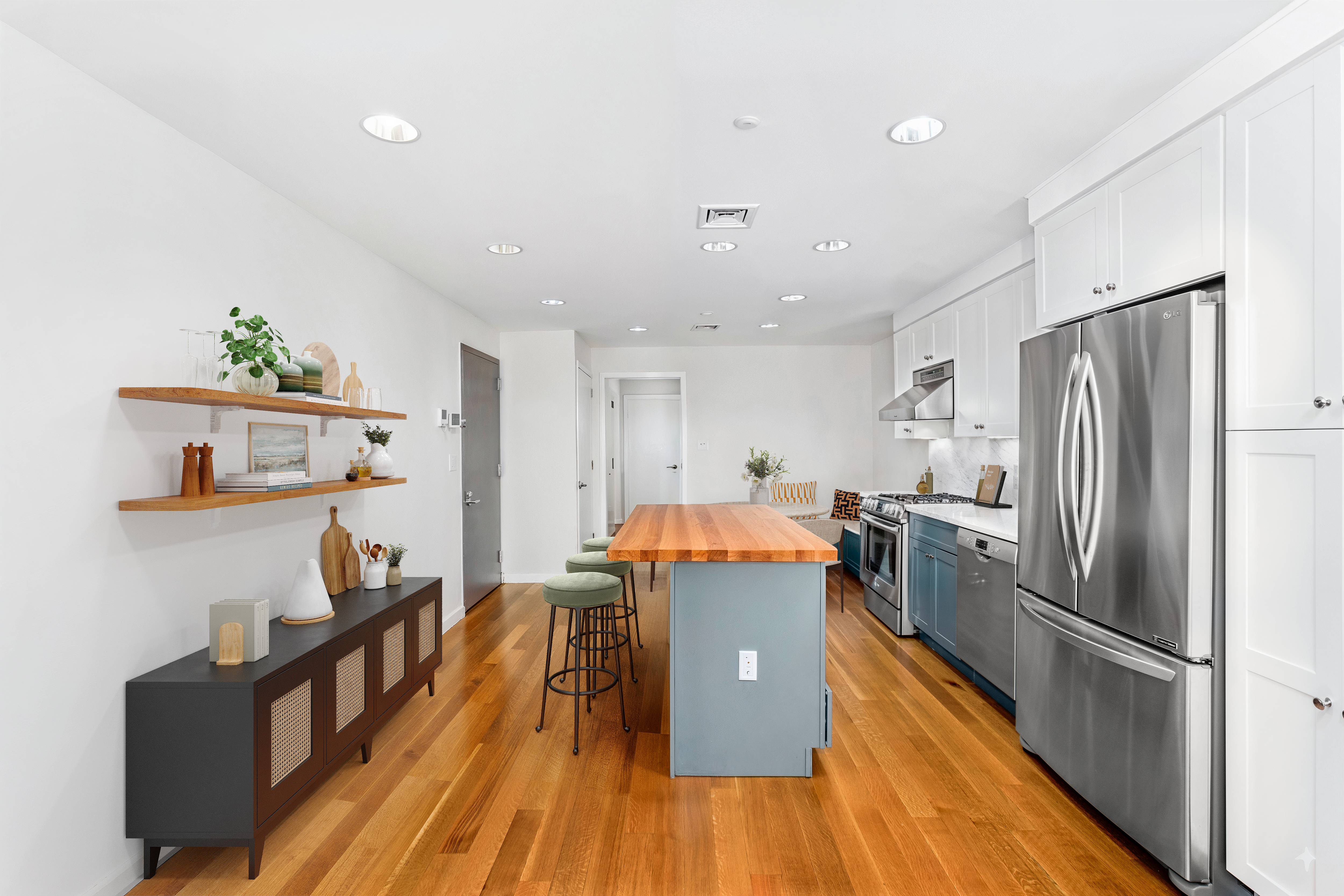 324 20th Street, Unit 2E Brooklyn, NY 11215 - Photo 3 of 11 a kitchen with stainless steel appliances a refrigerator a stove a sink and a dining table with wooden floor