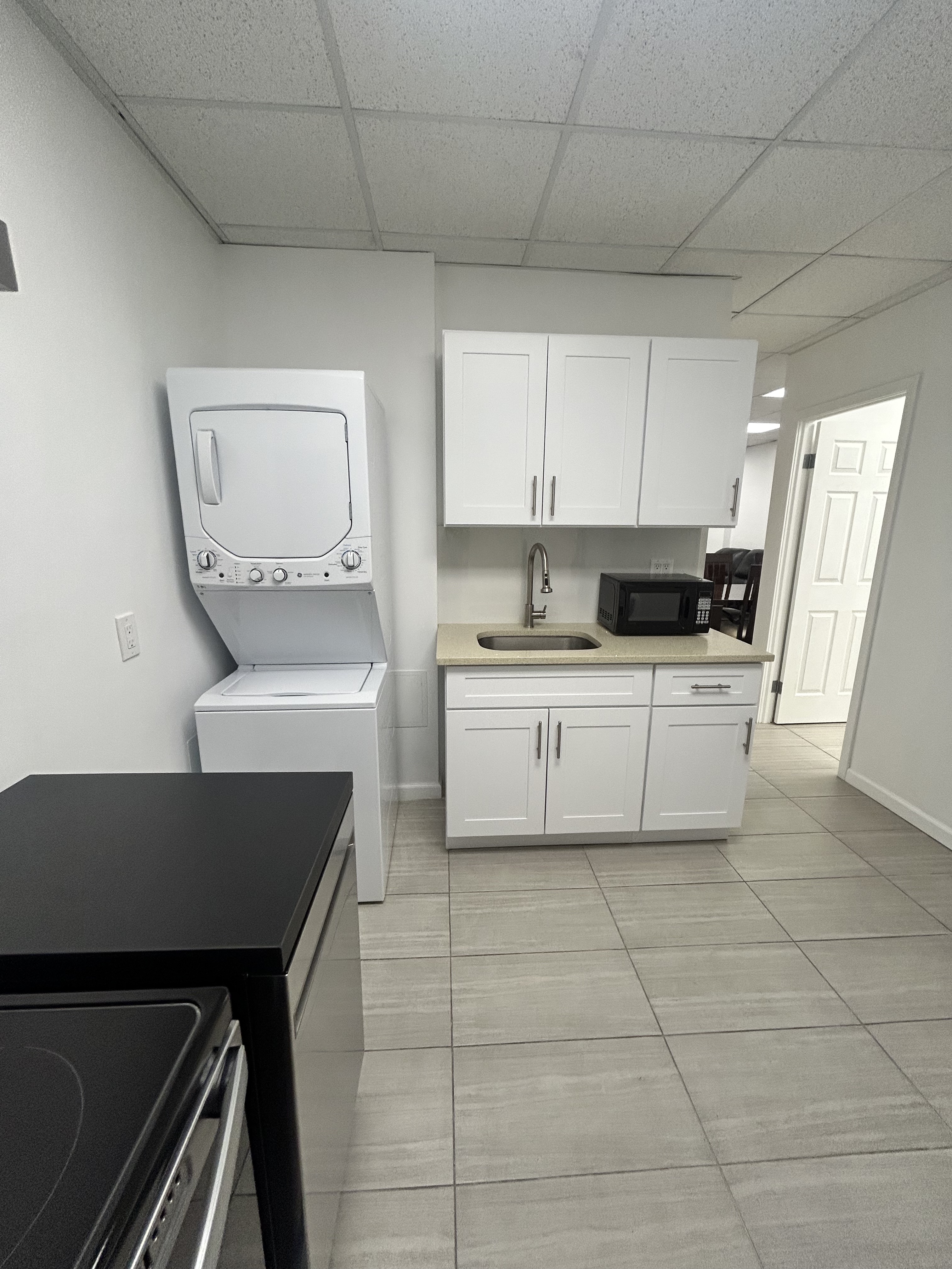 47 West 37th Street, Unit 4 Manhattan, NY 10018 - Photo 3 of 7 a kitchen with a sink a stove cabinets and a counter top space