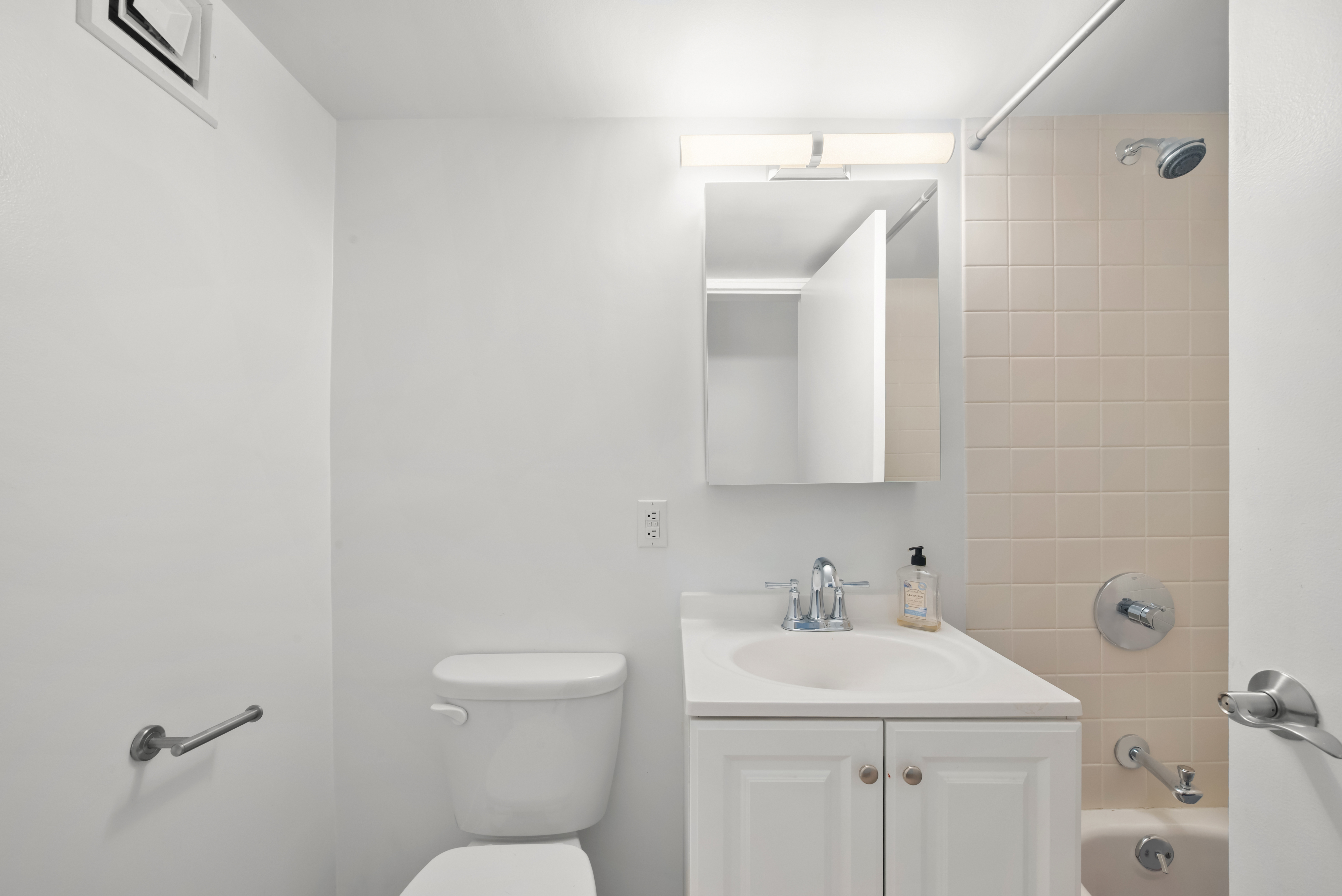 421 Hudson Street, Unit 504 Manhattan, NY 10014 - Photo 11 of 13 a bathroom with a sink a toilet and a mirror