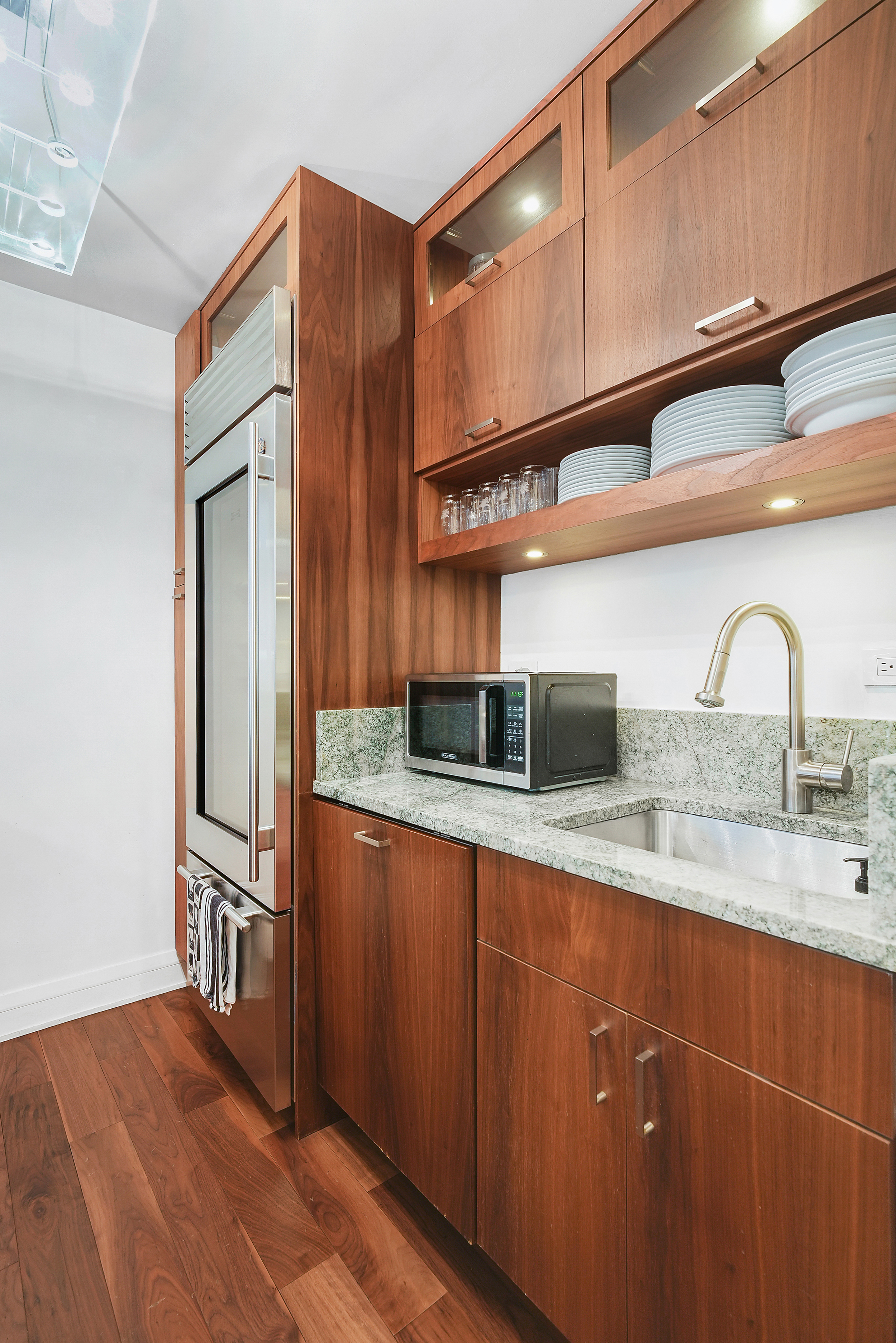 220 East 54th Street, Unit 11H Manhattan, NY 10022 - Photo 5 of 13 a kitchen with stainless steel appliances a sink and cabinets