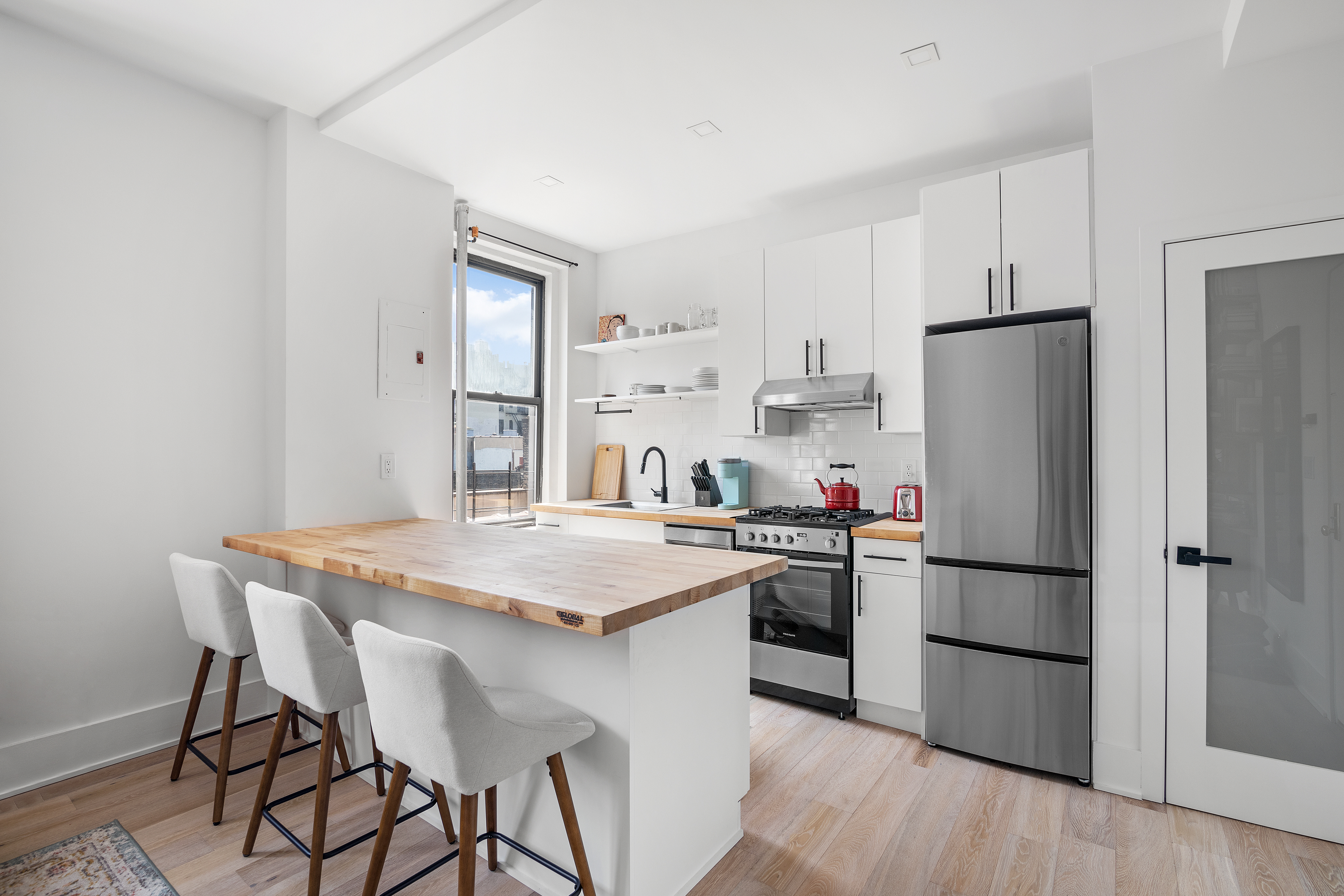 834 Riverside Drive, Unit E6 Manhattan, NY 10032 - Photo 2 of 22 a kitchen with stainless steel appliances granite countertop a refrigerator and a stove top oven