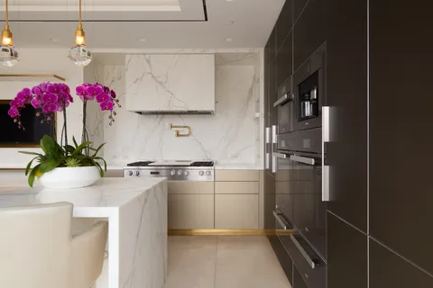 a kitchen with granite countertop a sink stainless steel appliances and cabinets