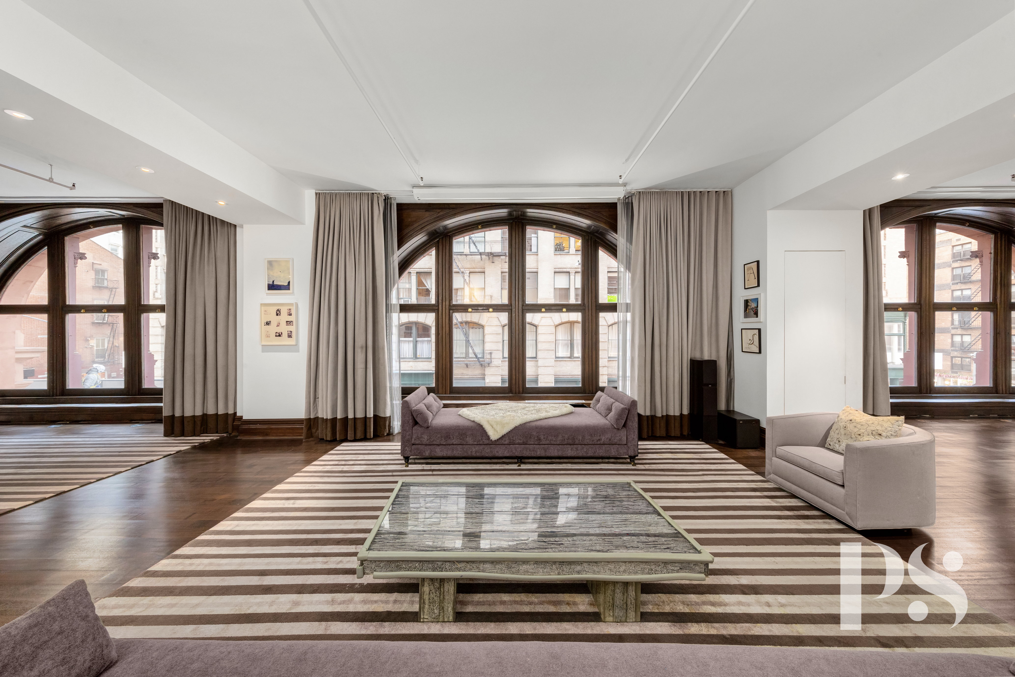 71-73 Bleecker Street, Unit 2E Manhattan, NY 10012 - Photo 3 of 18 a living room with large windows and a table