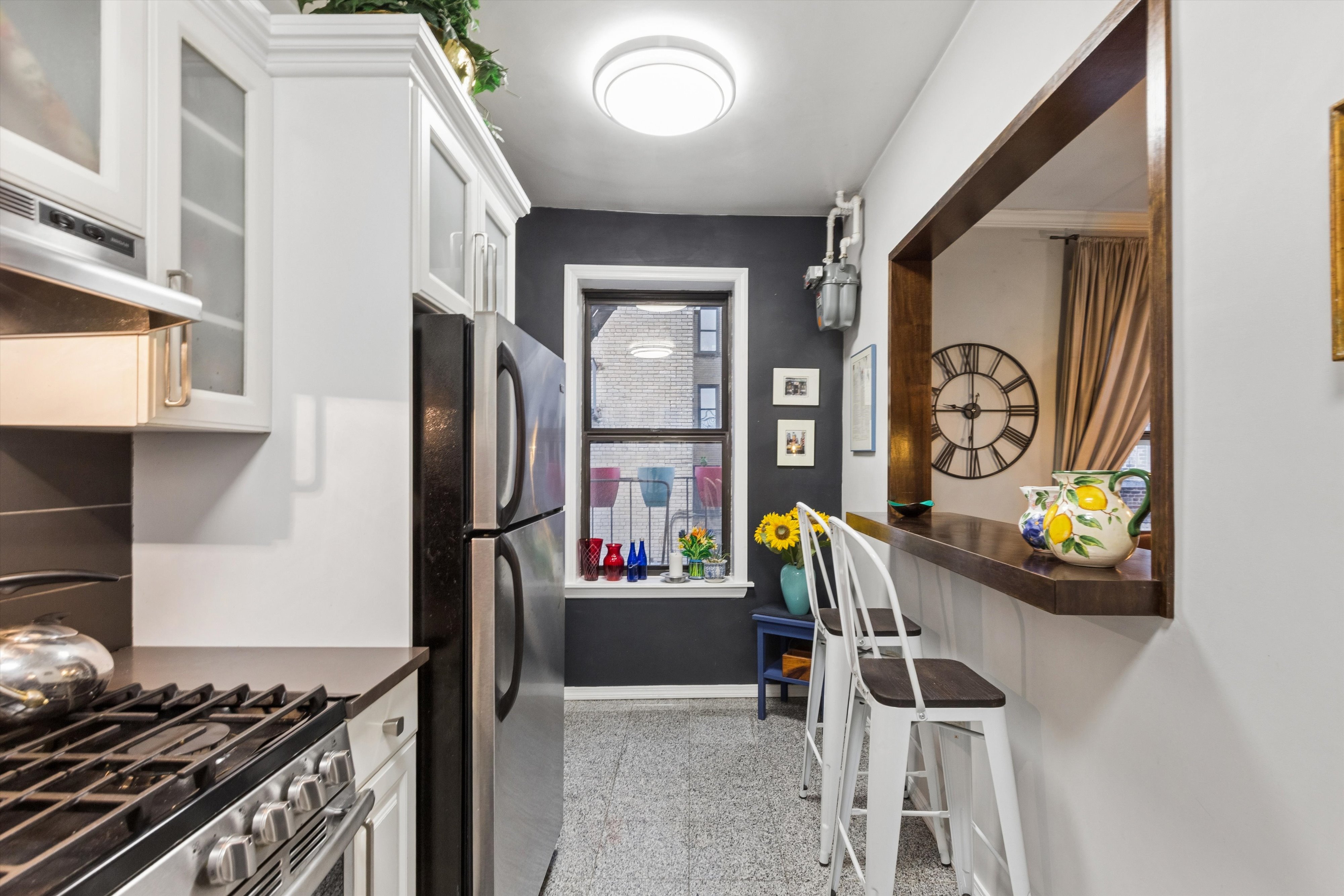 24 Bennett Avenue, Unit 62A Manhattan, NY 10033 - Photo 6 of 14 a kitchen with stainless steel appliances granite countertop a refrigerator and a stove
