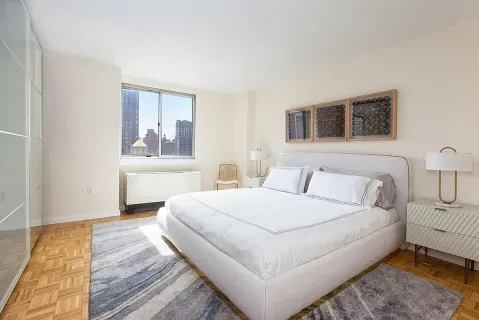 a large white bed in a white room