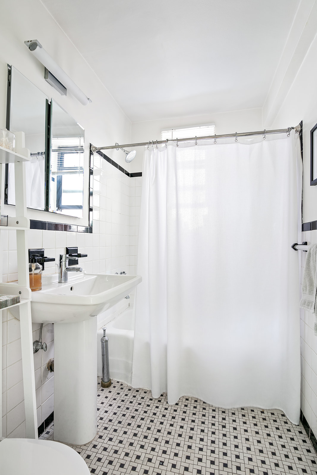 165 Christopher Street, Unit 5Y Manhattan, NY 10014 - Photo 5 of 9 a bathroom with a sink a toilet and shower