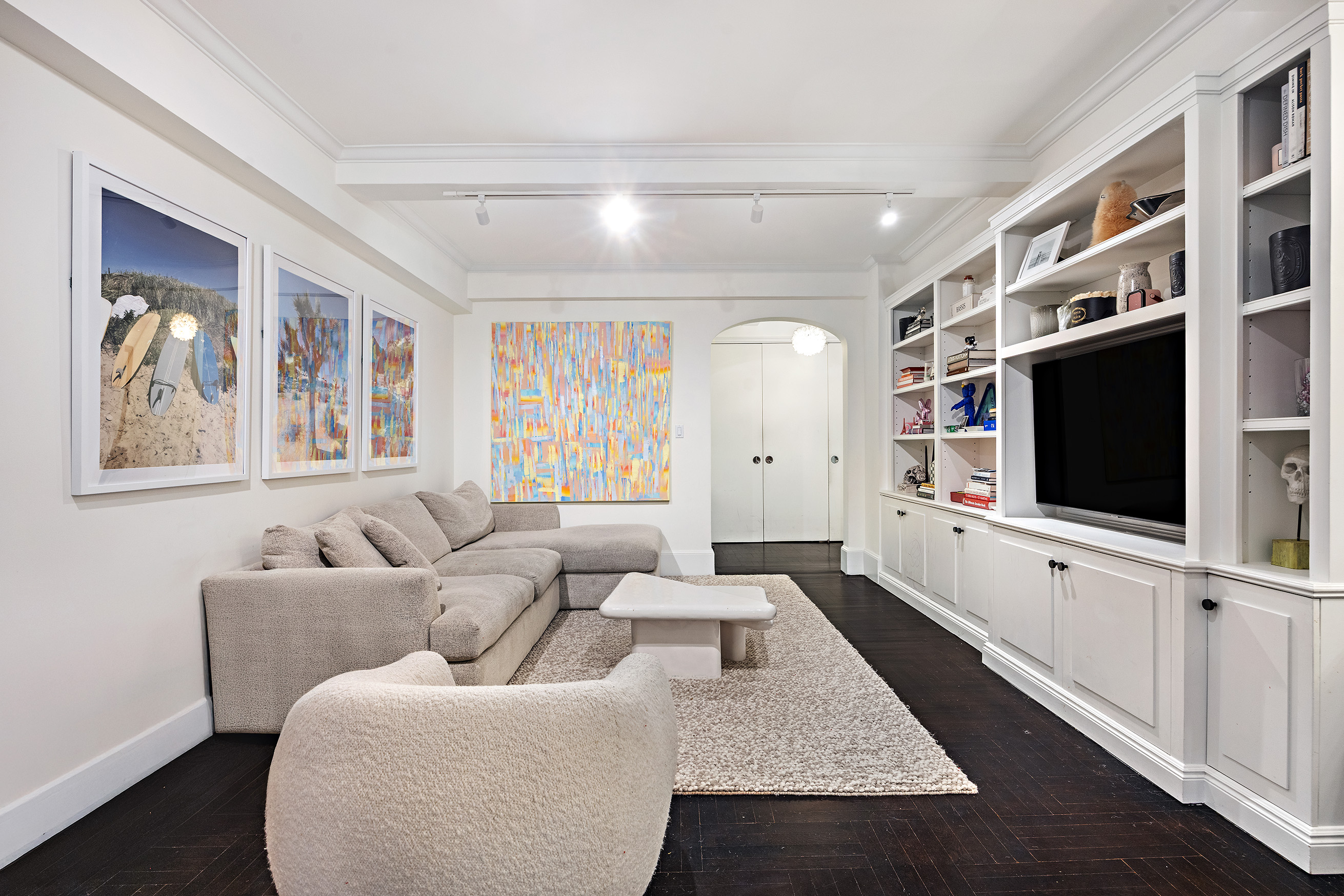 325 East 79th Street, Unit 6C Manhattan, NY 10075 - Photo 2 of 17 a living room with furniture and a flat screen tv