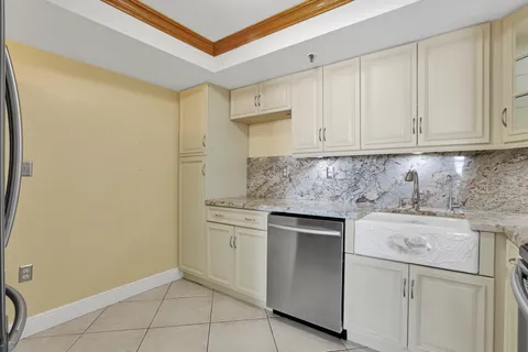 a kitchen with a sink cabinets and appliances
