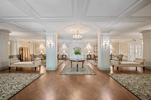 a living room with furniture and a chandelier