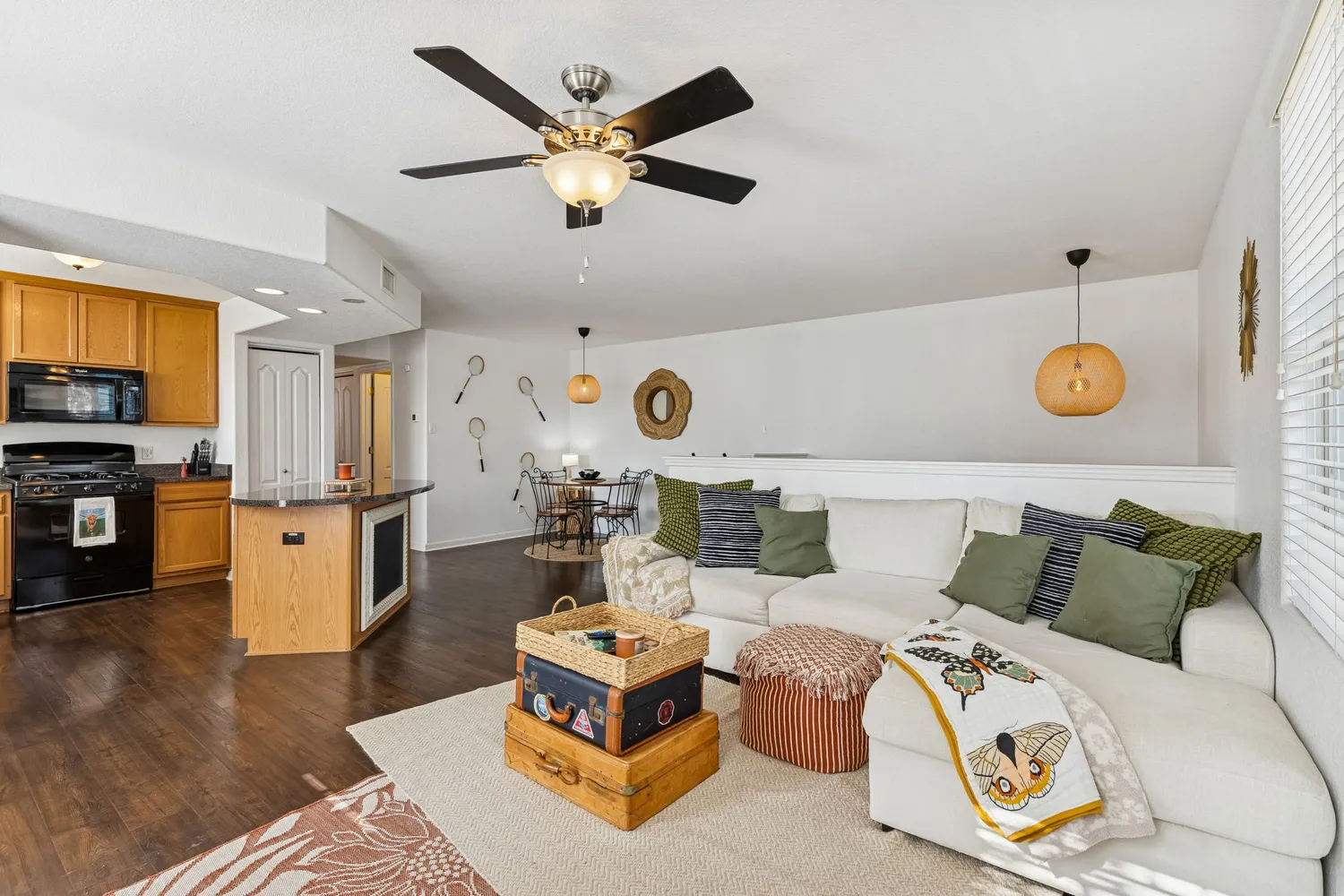 a living room with furniture and wooden floor