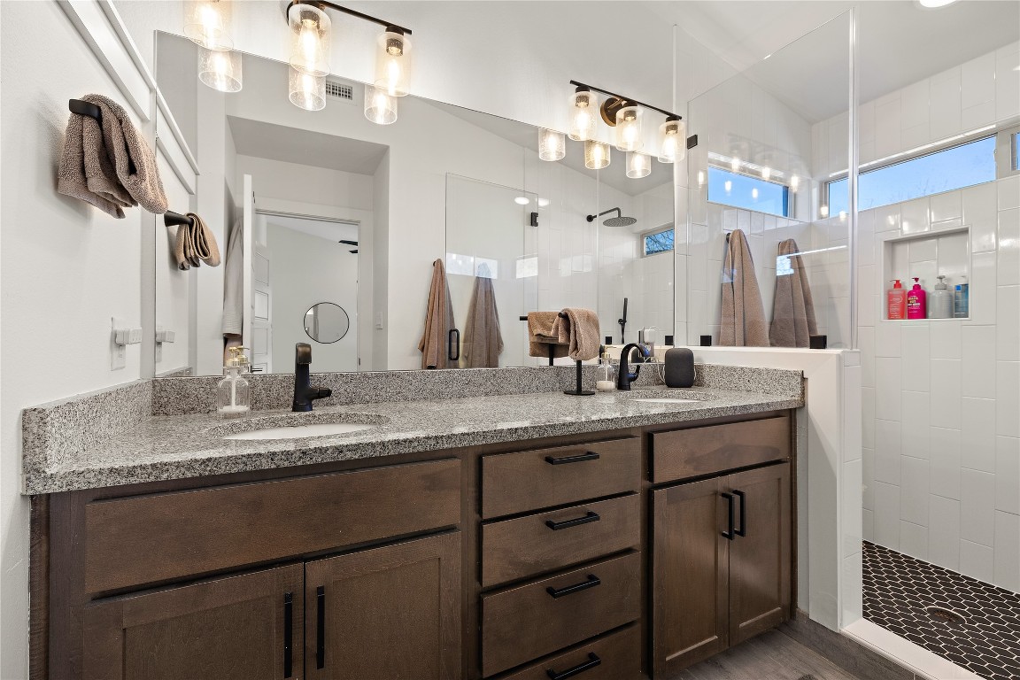 1402 Singleton Avenue, Unit B Austin, TX 78702 - Photo 18 of 26 a bathroom with a granite countertop sink vanity and mirror