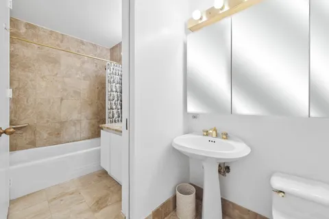 a bathroom with a sink a toilet and a bathtub