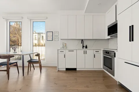 a view of kitchen with furniture and wooden floor