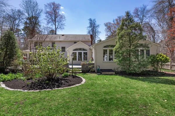 an aerial view of a house with a yard and trees