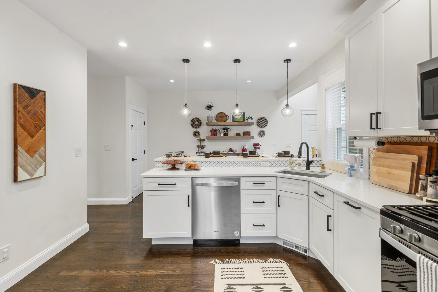 1 Maple Street, Unit 1 Maynard, MA 01754 - Photo 13 of 42 a kitchen with kitchen island white cabinets and white appliances