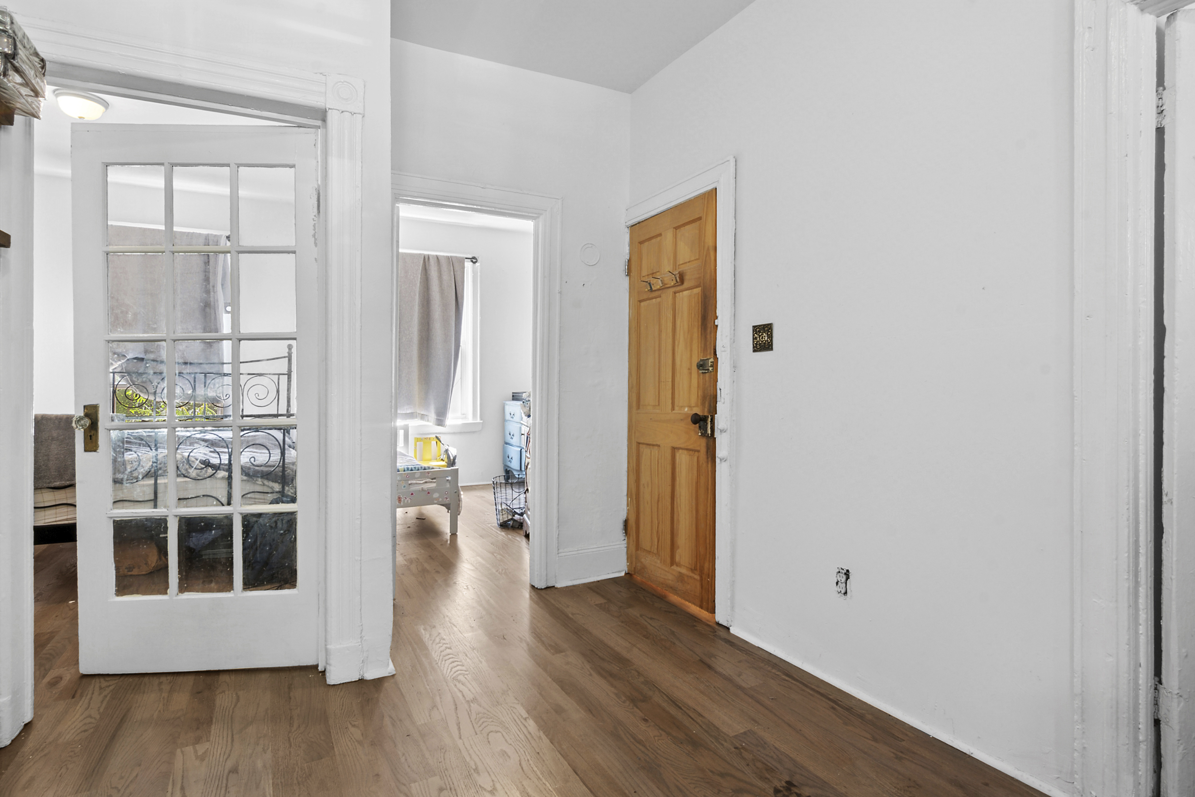464 East New York Avenue Brooklyn, NY 11225 - Photo 3 of 6 a view of a hallway with wooden floor and windows