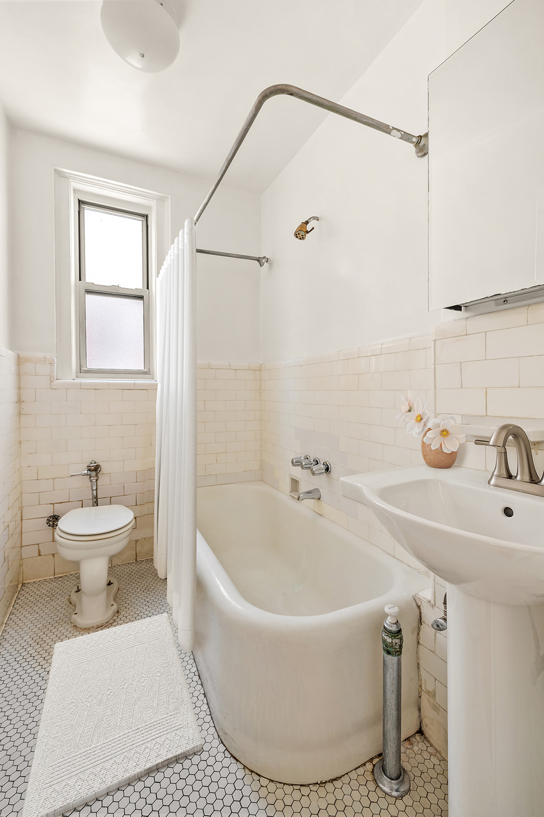 345 West 55th Street, Unit 8AB Manhattan, NY 10019 - Photo 6 of 14 a bathroom with a sink and a bathtub