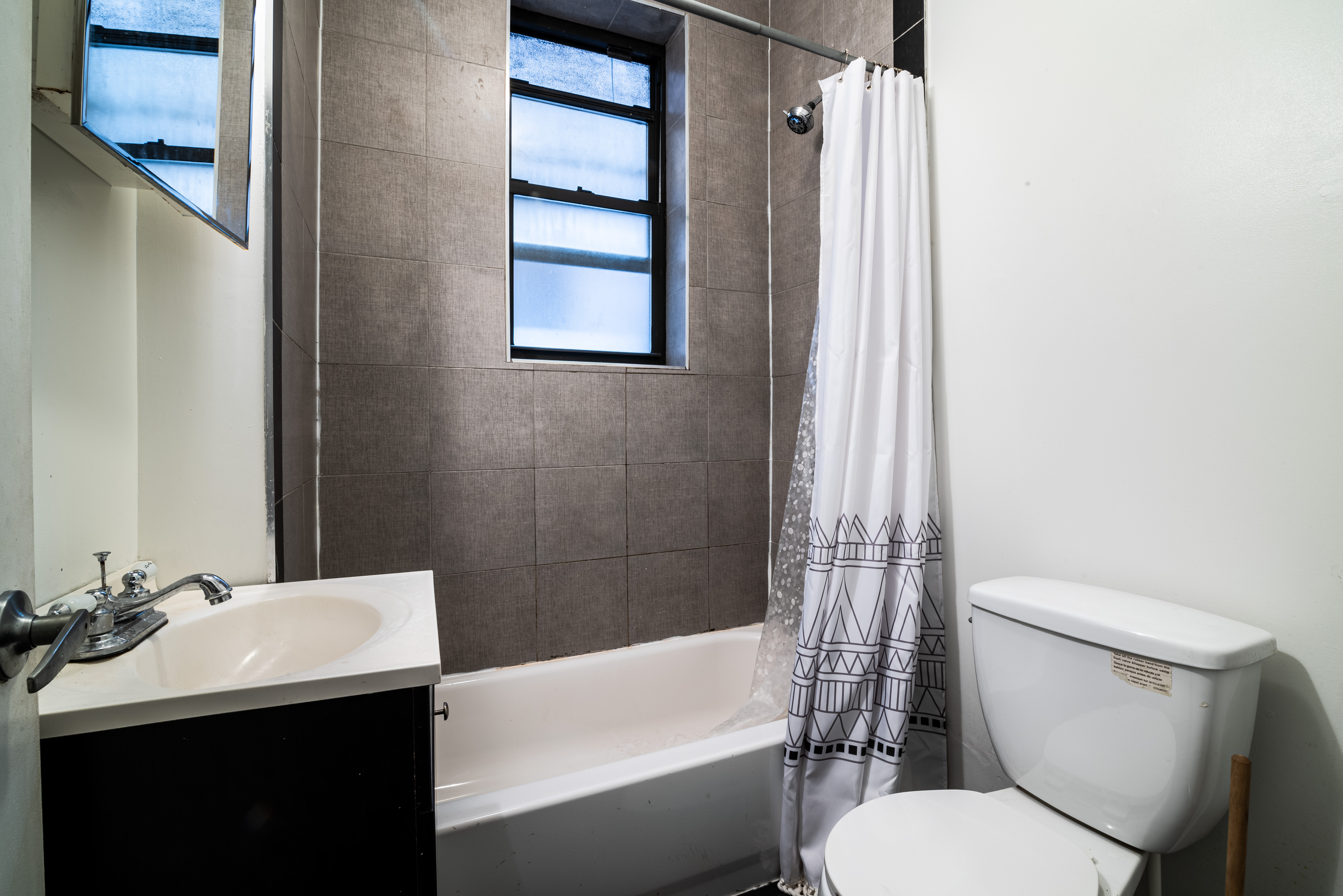 681 Sterling Place, Unit 2L Brooklyn, NY 11216 - Photo 7 of 8 a bathroom with a sink toilet and shower