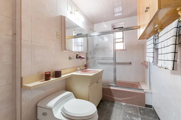 a white toilet sitting next to a bath tub