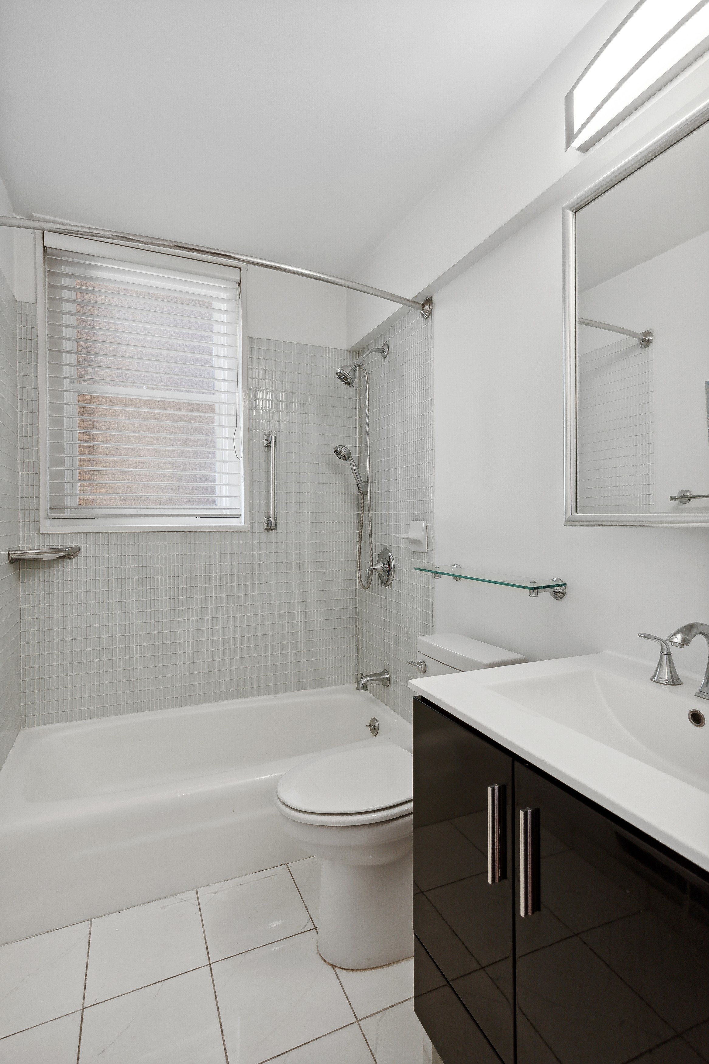 444 East 86th Street, Unit 11B Manhattan, NY 10028 - Photo 10 of 18 a bathroom with a sink a toilet and shower