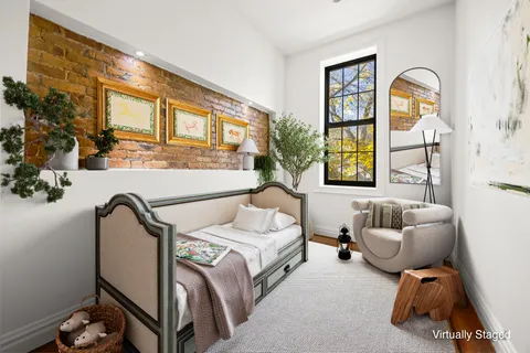 a bedroom with a bed and a large window