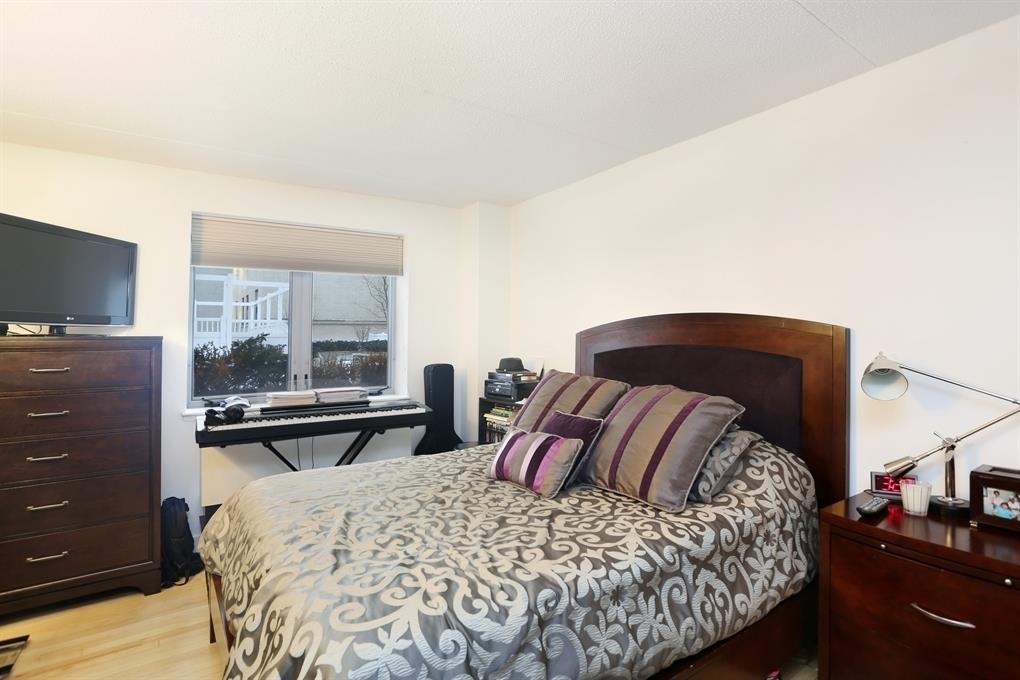 53 Boerum Place, Unit 2J Brooklyn, NY 11201 - Photo 3 of 9 a bedroom with a bed and wooden floor