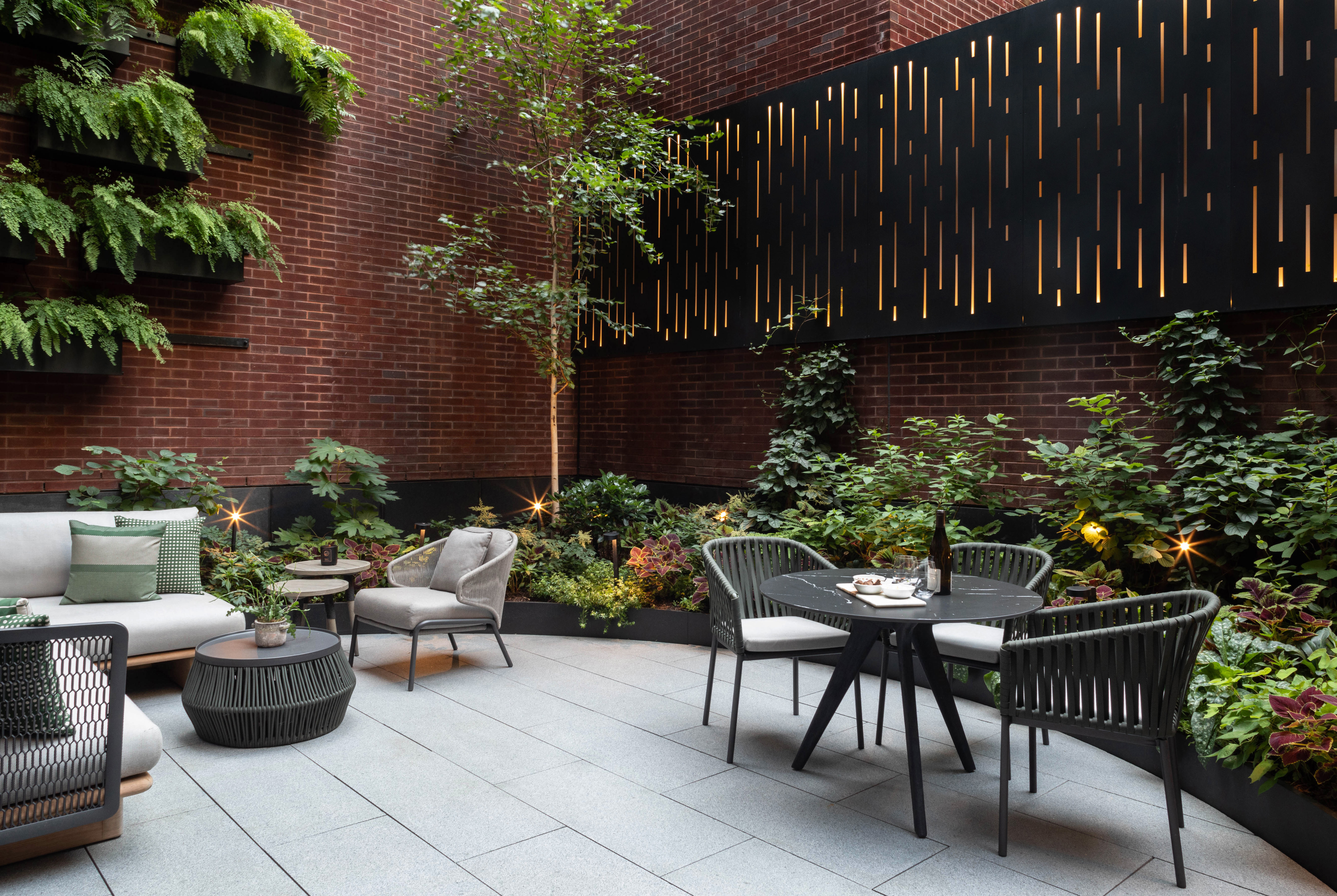 150 Charles Street, Unit M10 Manhattan, NY 10014 - Photo 24 of 34 a view of a patio with table and chairs and potted plants