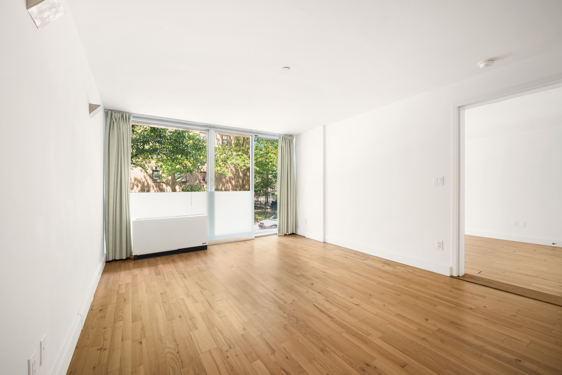 420 West 25th Street, Unit 2K Manhattan, NY 10001 - Photo 5 of 18 a view of a big room with wooden floor and windows