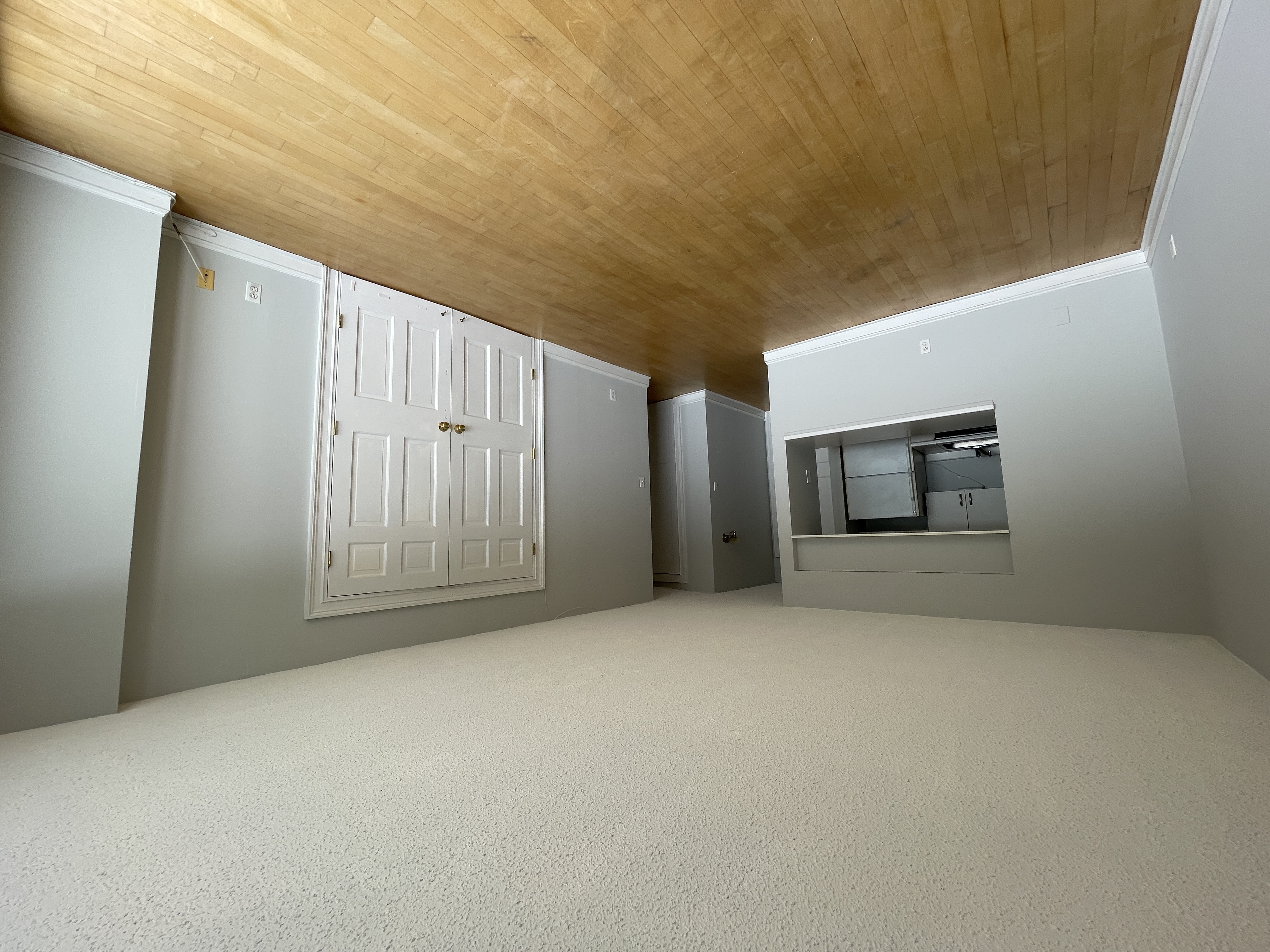 25-40 Shore Boulevard, Unit 8G Queens, NY 11102 - Photo 3 of 25 a view of an empty room with wooden floor and a window