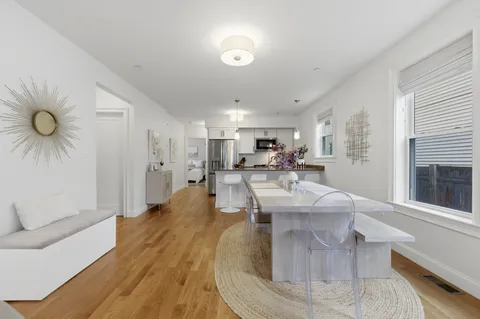 a large white kitchen with a large window