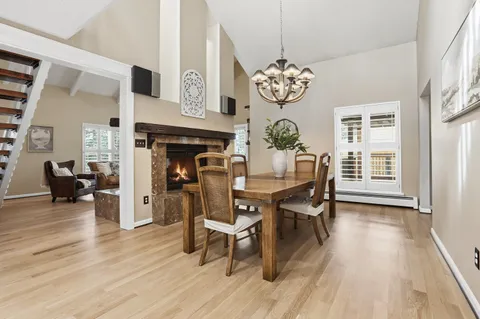 a view of a dining room with furniture wooden floor and a chandelier