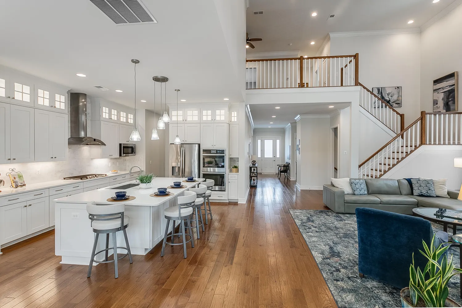 a kitchen with stainless steel appliances kitchen island granite countertop a living room dining room and kitchen view