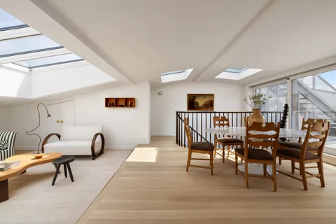 a dining room with furniture and a window