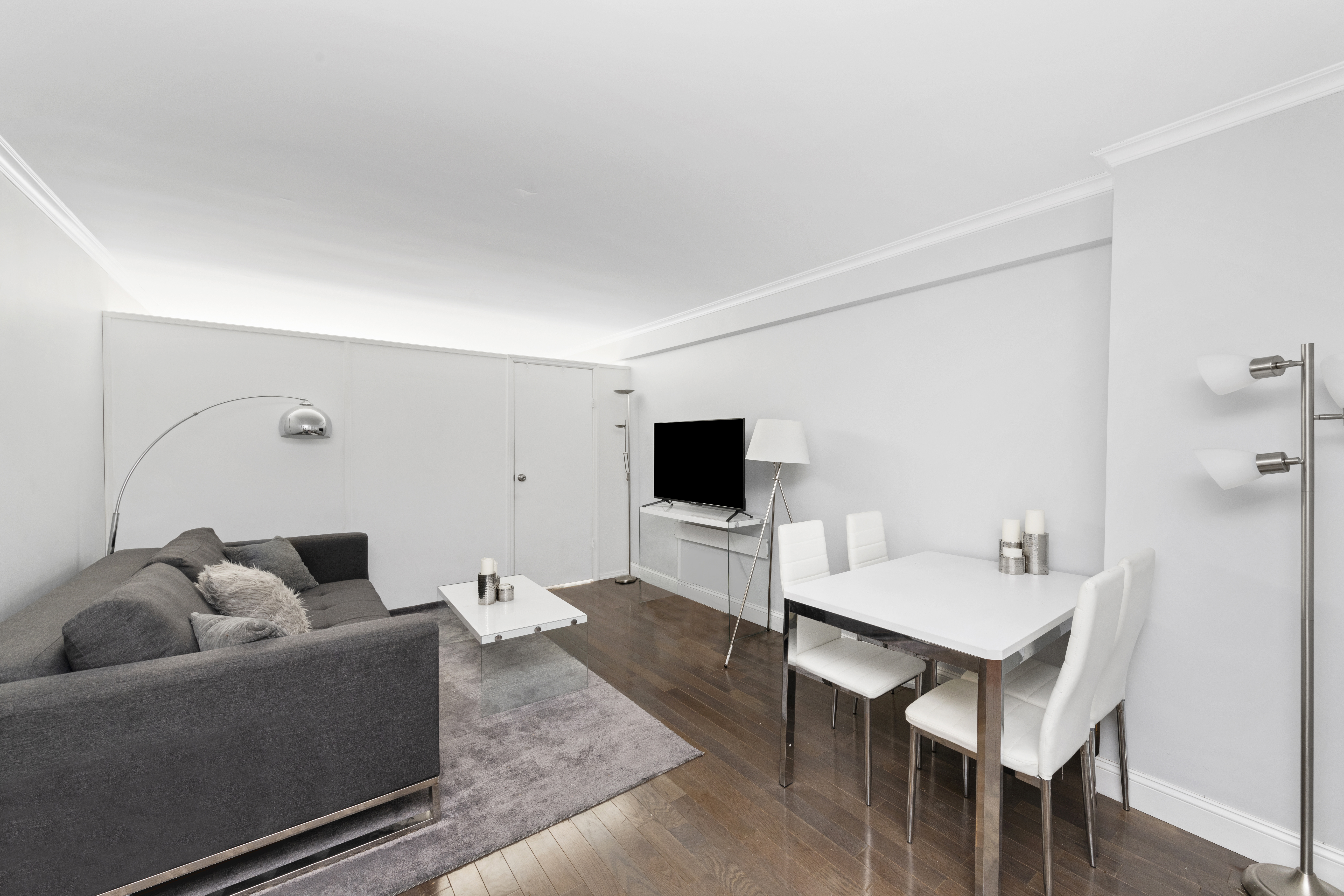 333 East 34th Street, Unit 10H Manhattan, NY 10016 - Photo 4 of 16 a living room with furniture and a flat screen tv