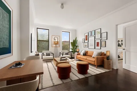 a living room with fireplace furniture and a large window
