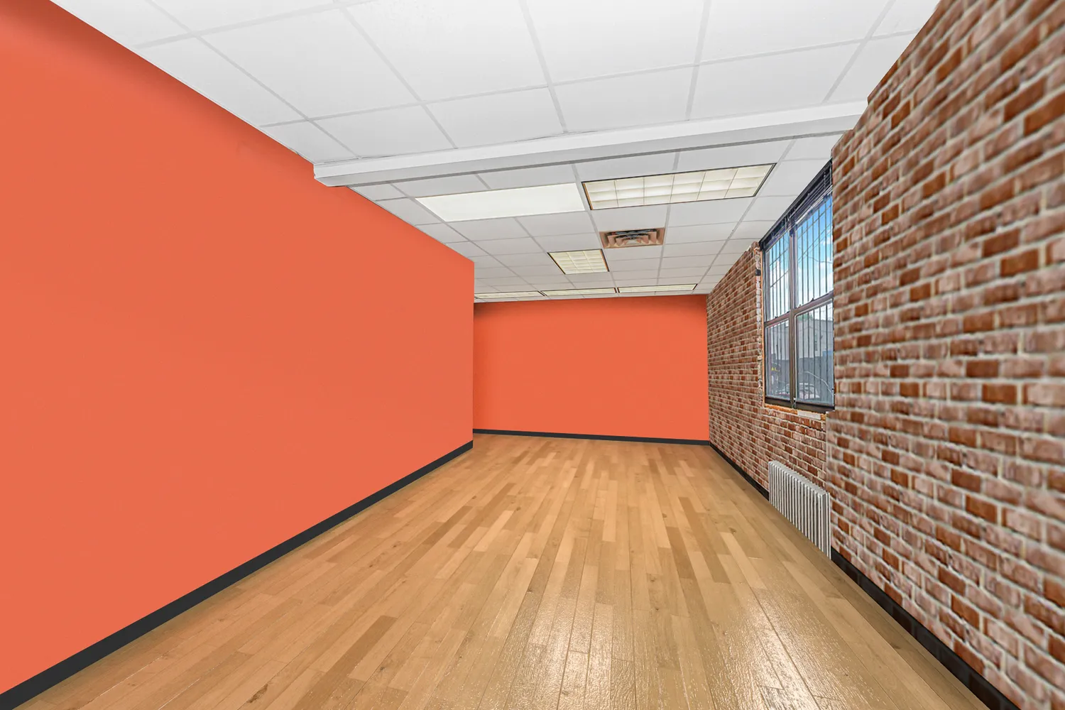 a view of an empty room and wooden floor