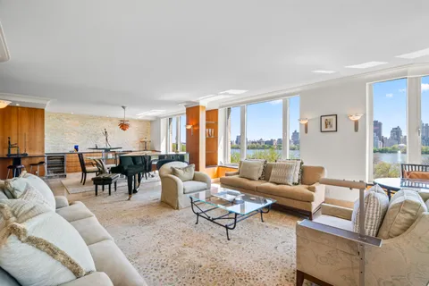 a living room with furniture wooden floor and a large window