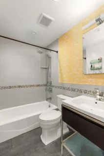 a bathroom with a sink a toilet and bathtub