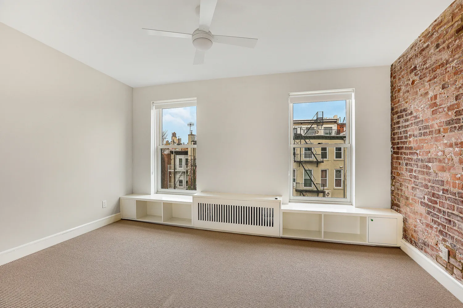 an empty room with windows and closet