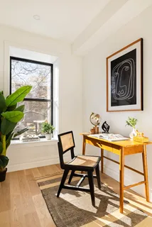 a house sitting area with furniture and a potted plant
