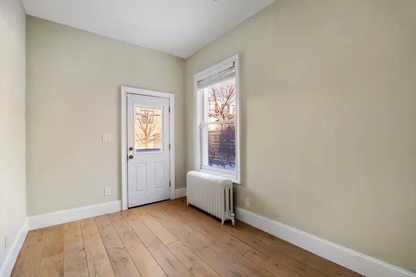 a view of room with window and hardwood floor