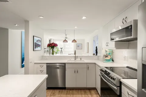 a kitchen with a sink stove and cabinets