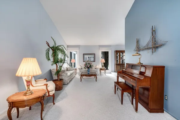 a living room with furniture and a lamp