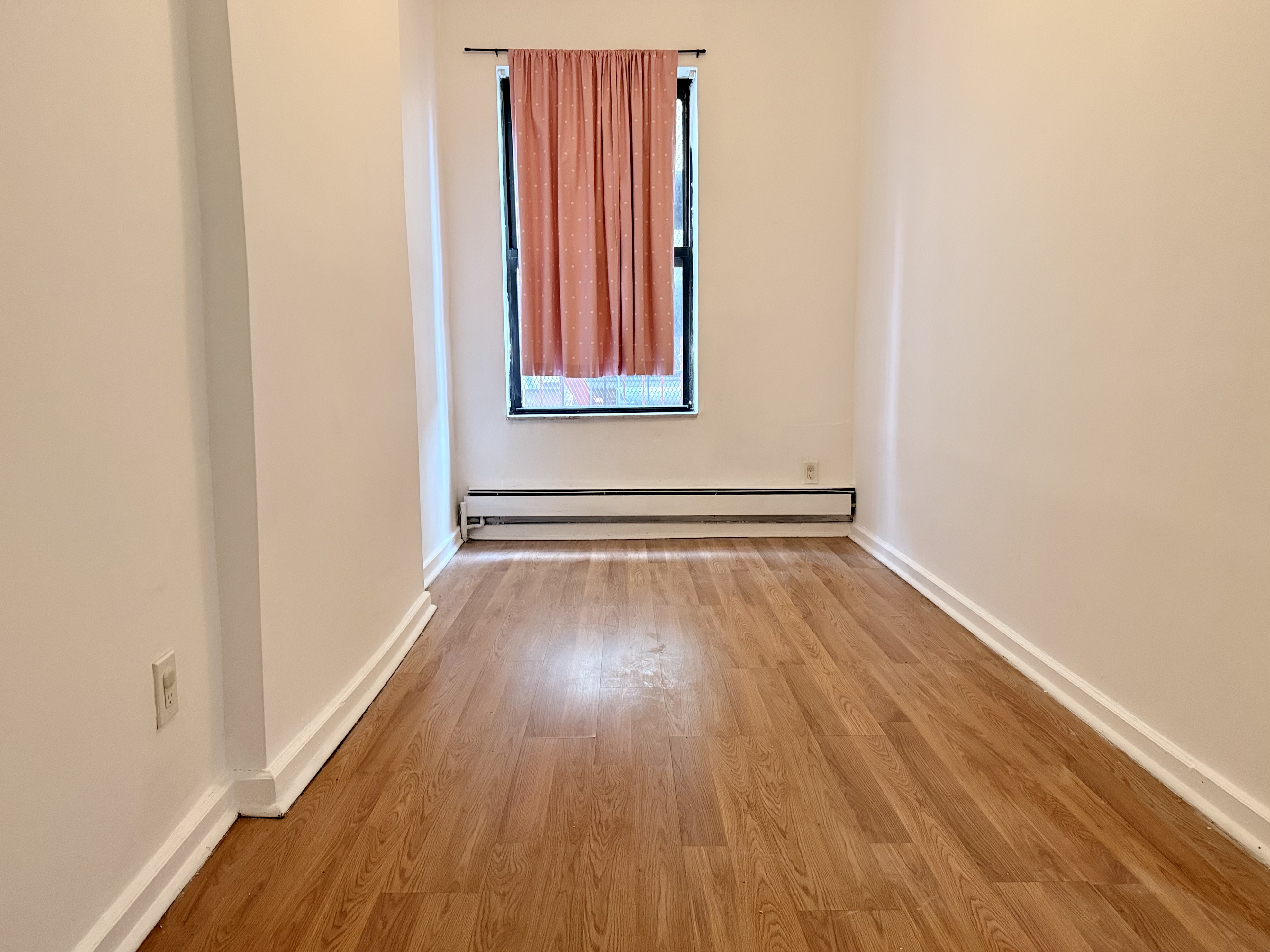 1997 3rd Avenue, Unit 1A Manhattan, NY 10029 - Photo 16 of 23 a view of a room with wooden floor and a window